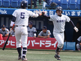 本塁打を放ち、松本（2年）とハイタッチする田中宗一郎（4年）
